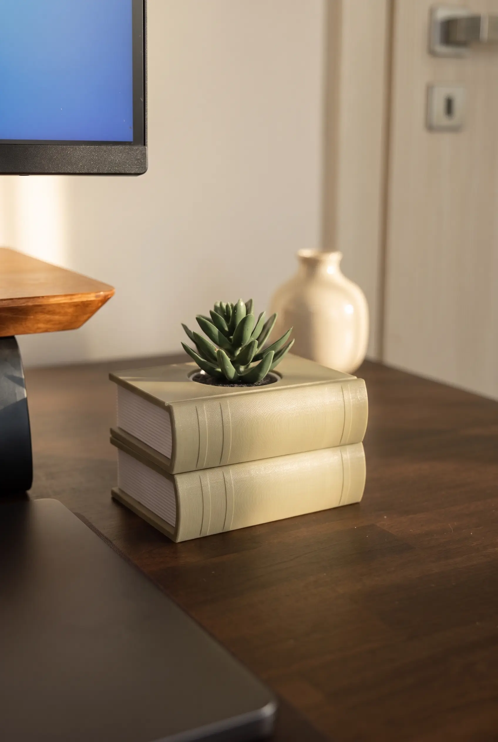Two-book BOOKSTACK planter beside a desk