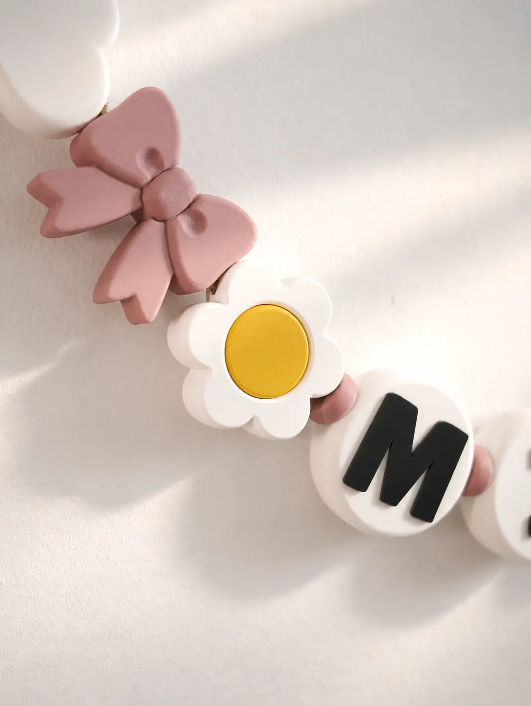 Bow, flower and letter details on the MIA garland