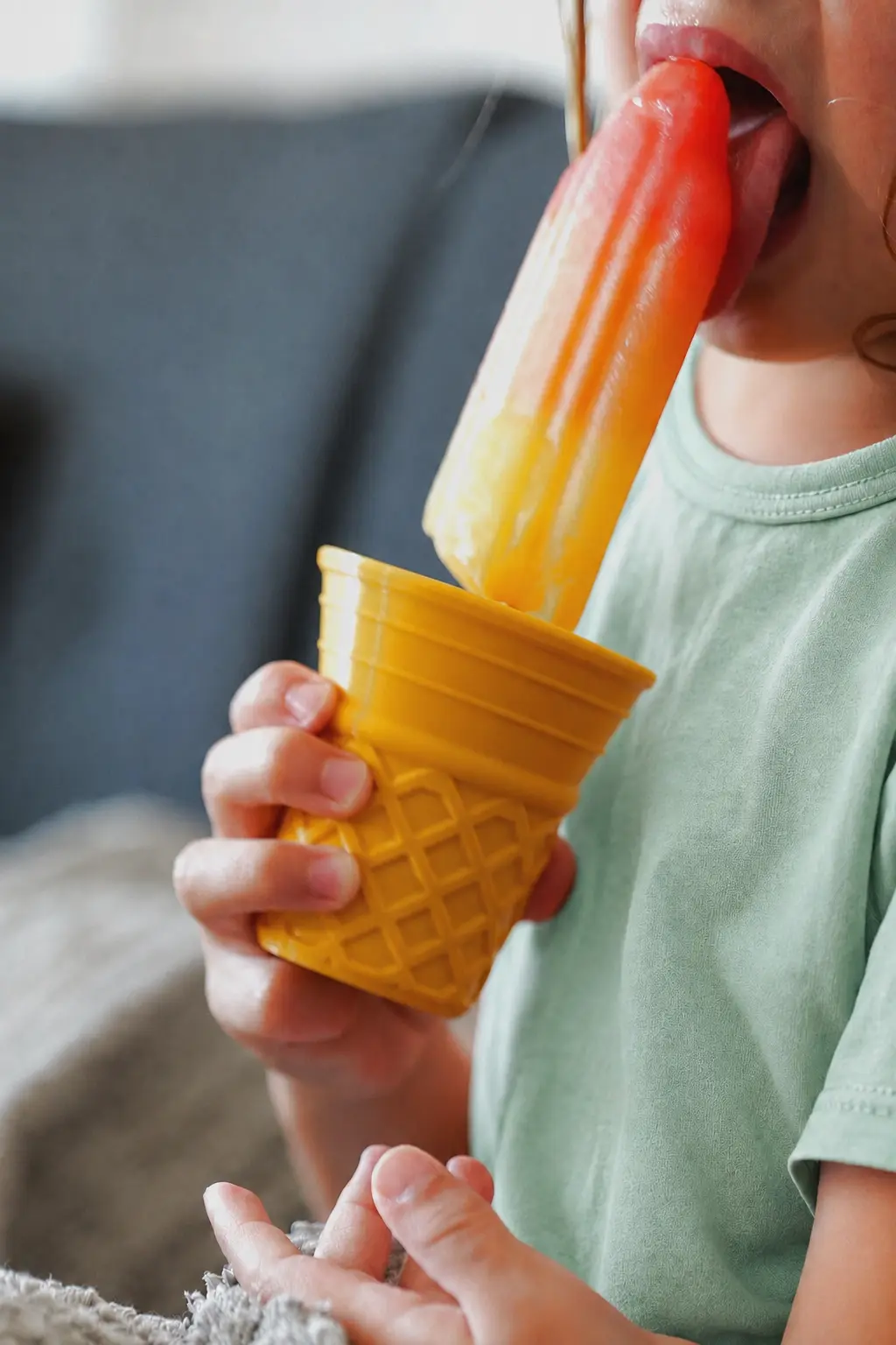 Child using the Popsicle Drip-Catcher